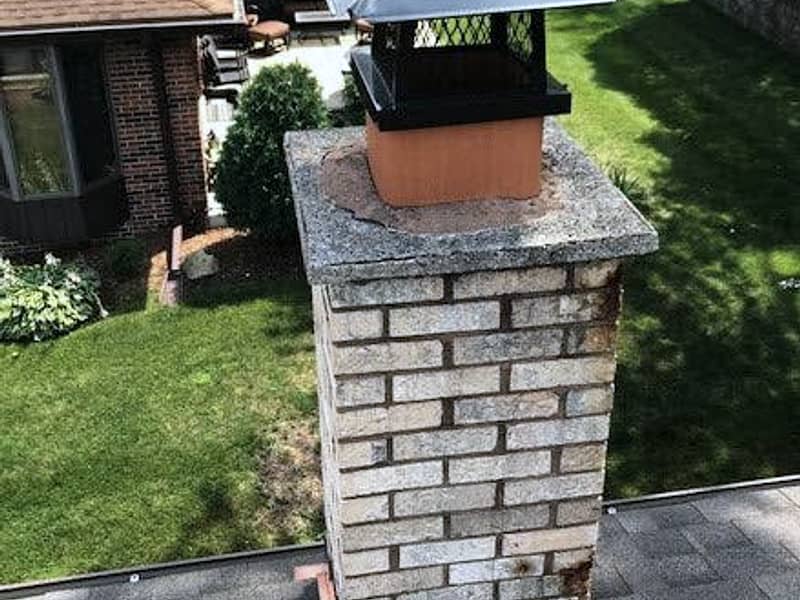 screened cap fitted to keep animals out on a chimney in Hamilton, NJ