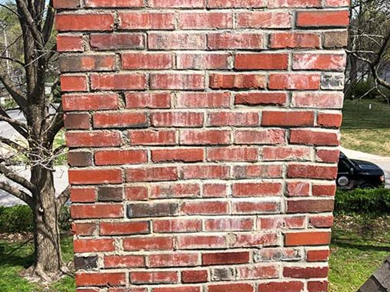 weathered brick face with open mortar joints on a chimney in Hamilton, NJ