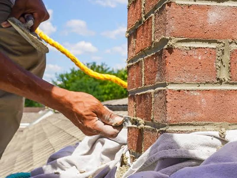 fresh mortar worked into the brick joints on a chimney in Hamilton, NJ