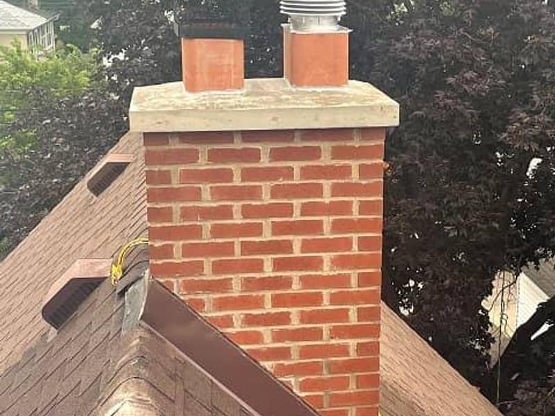 rebuilt brick stack finished with a new crown on a chimney in Hamilton, NJ