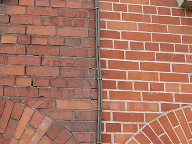 old joints beside freshly repointed brickwork on a chimney in Hamilton, NJ
